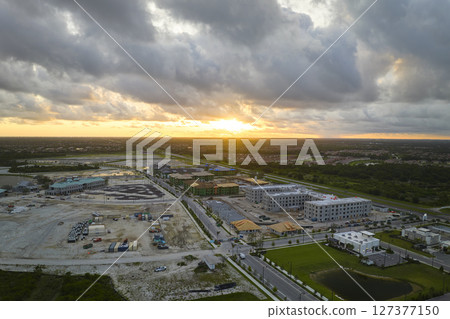 View from above of unfinished frame of apartment condos with wooden roof beams under construction. Development of residential housing in US suburbs. Real estate market in the USA 127377150