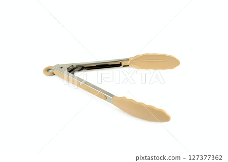 Close-up kitchen tongs isolated on white background. Close-up kitchen tongs isolated on white background. 127377362