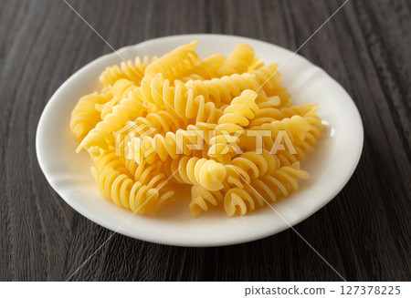 Fusilli, dried short pasta served on a plate Fusilli, dried short pasta served on a plate 127378225