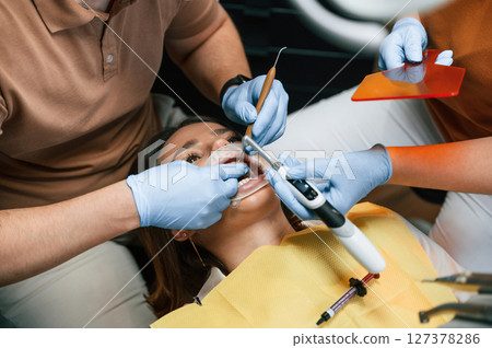 Procedure of installation of aligner in progress. Woman in the stomatology clinic, visiting dentist 127378286