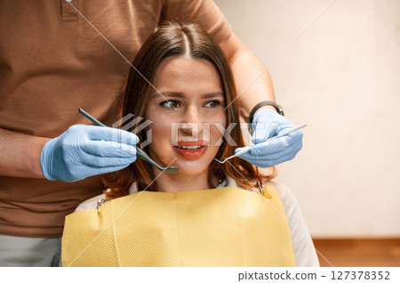 Checking the aligner on teeth. Woman in the stomatology clinic, visiting dentist 127378352