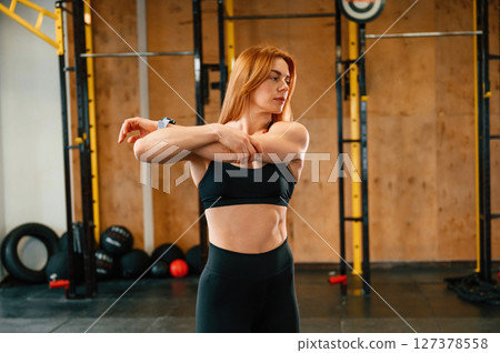 Warm up exercises. Beautiful strong woman is in the gym 127378558