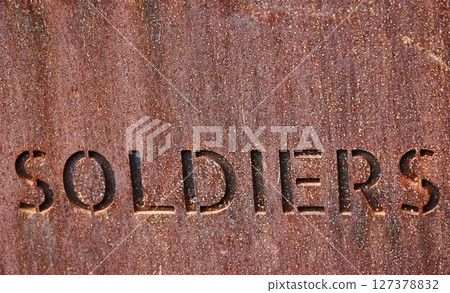 Soldiers word writen on metal plaque 127378832