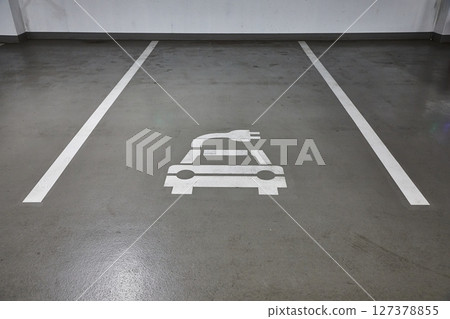 Electric car charging station in a carpark 127378855