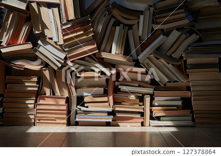 Wall of books piled up in the attic 127378864