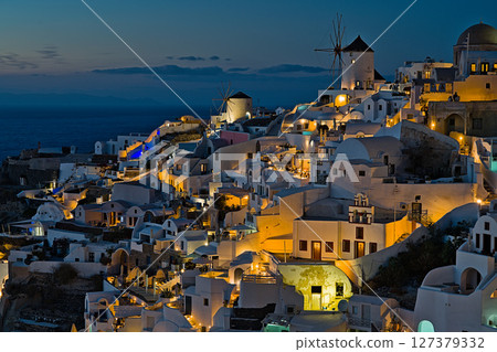 Sunset over the city of Ia with illuminated buildings Sunset over the city of Ia with illuminated buildings 127379332