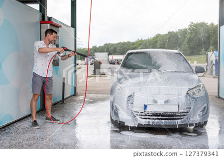Vehicle cleaning. Automobile car wash soap. Foam spray water exterior detail. Vehicle cleaning. Automobile car wash soap. Foam spray water exterior detail. 127379341