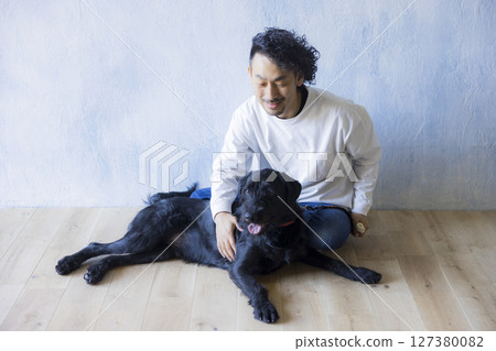 Man relaxing with his dog 127380082