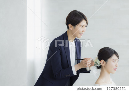 Bride doing hair and makeup 127380251