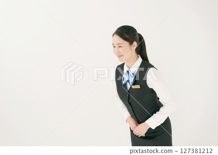 A woman in uniform bowing A woman in uniform bowing 127381212