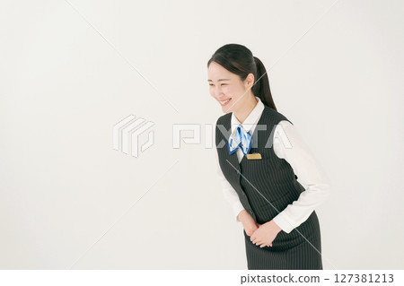 A woman in uniform bowing 127381213