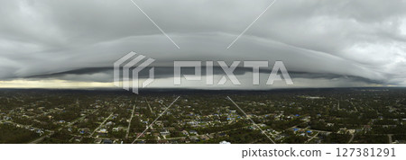 Tropical storm in Florida. Stormy clouds forming during heavy thunderstorm on dark sky. Moving and changing cloudscape weather 127381291