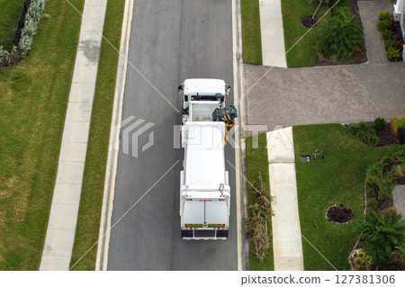 Trash truck picking up garbage bins on Florida city street curbside Trash truck picking up garbage bins on Florida city street curbside 127381306