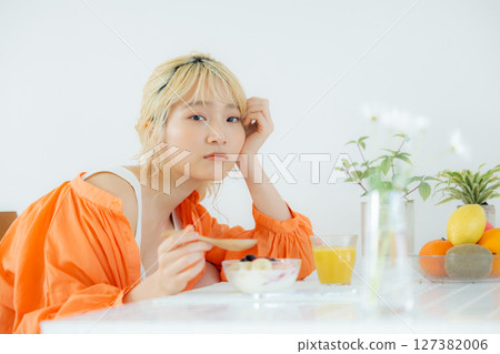 A woman eating breakfast A woman eating breakfast 127382006