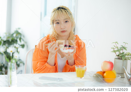 A woman eating breakfast A woman eating breakfast 127382020