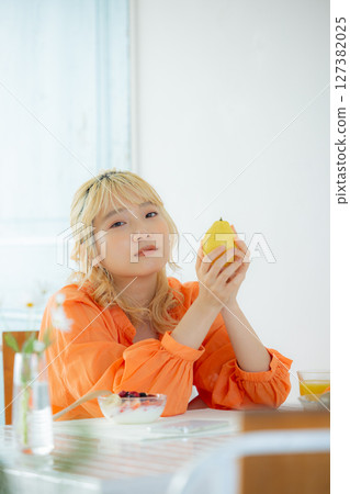 A woman eating breakfast A woman eating breakfast 127382025