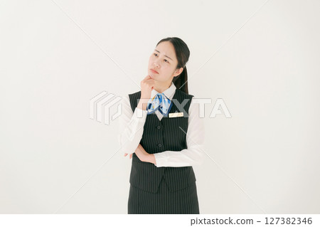 A woman in office clothes with a thinking expression 127382346