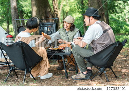 A friendly family enjoying day camping, camping and barbecues at a park or campsite A friendly family enjoying day camping, camping and barbecues at a park or campsite 127382401