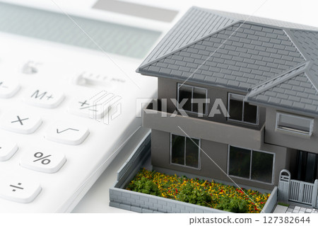 Calculator and miniature detached house Calculator and miniature detached house 127382644