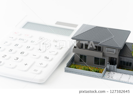 Calculator and miniature detached house Calculator and miniature detached house 127382645