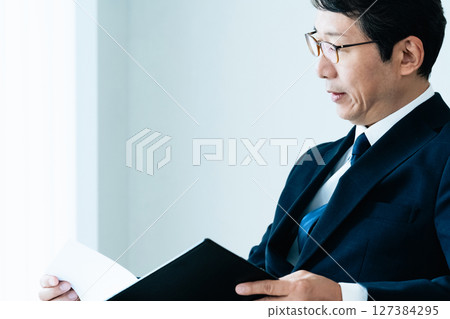 Businessmen checking materials 127384295