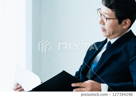 Businessmen checking materials Businessmen checking materials 127384296