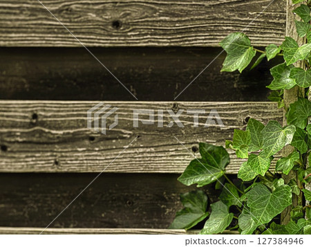 A mixed classic background featuring weathered wooden planks with a dark finish.  127384946