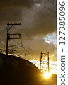 Sunset and backlit electric pole 127385096