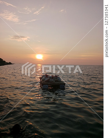 sunset on the sea with little boat sunset on the sea with little boat 127385341