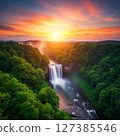A brilliant sunset and a deep green waterfall - a fantastical Japanese landscape 127385546