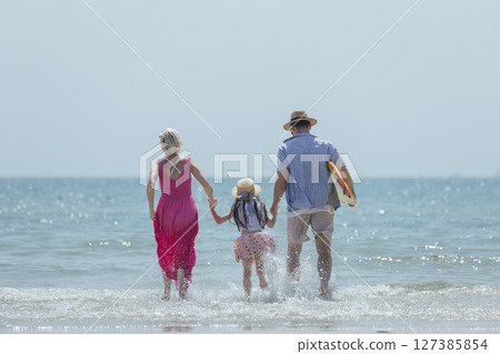 Family happy relaxing on beach children mother father travel summer vacation together sea holiday tropical. Trip enjoying bonding. Family day having fun. Family happy relaxing on beach children mother father travel summer vacation together sea holiday tropical. Trip enjoying bonding. Family day having fun. 127385854