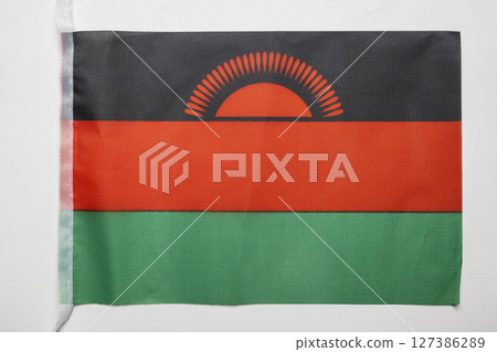 Closeup view of the Malawi national flag isolated over a white background. Concept of government and nationality Closeup view of the Malawi national flag isolated over a white background. Concept of government and nationality 127386289