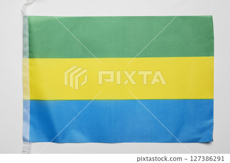 Closeup view of the Gabon national flag isolated over a white background. Concept of government and nationality 127386291