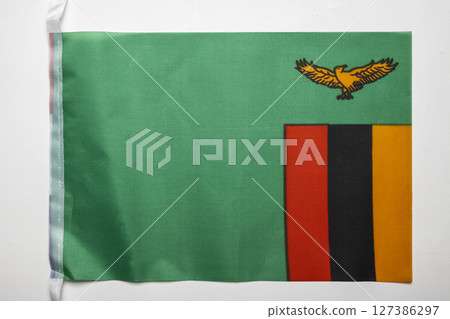 Closeup view of the Zambia national flag isolated over a white background. Concept of government and nationality Closeup view of the Zambia national flag isolated over a white background. Concept of government and nationality 127386297