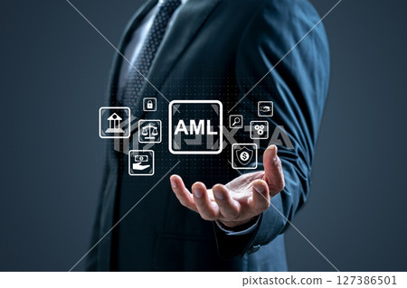 Businessman showing an icon of AML. Technology innovation on a virtual screen. Concept of Anti Money Laundering Businessman showing an icon of AML. Technology innovation on a virtual screen. Concept of Anti Money Laundering 127386501