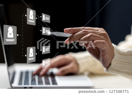 Businesswoman using laptop while touching the flowchart icon of a human representing potential candidates. Technology innovation on a virtual screen. Concept of human resources recruitment and hiring Businesswoman using laptop while touching the flowchart icon of a human representing potential candidates. Technology innovation on a virtual screen. Concept of human resources recruitment and hiring 127386771
