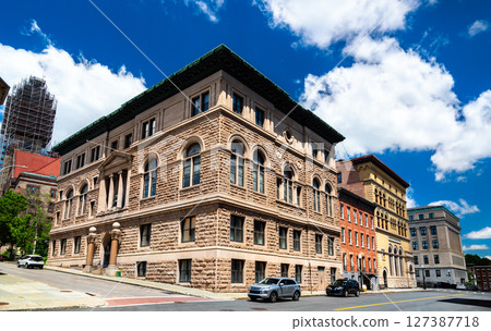 Renaissance Revival Albany Masonic Temple built in 1896 in Albany, United States, shows massive rusticated stone walls, arched windows, and green copper cornice under a vivid blue summer sky 127387718