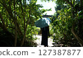 A woman walking along a narrow road on Yubu Island 127387877