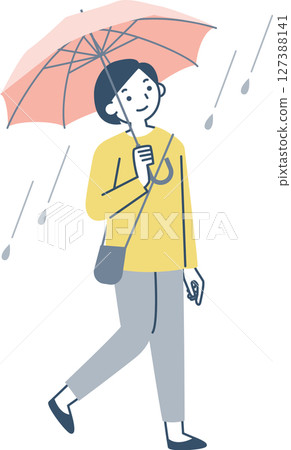 A woman walking with an umbrella on a rainy day 127388141