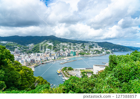 [Shizuoka Prefecture] Atami cityscape with various buildings lined up along the coast 127388857