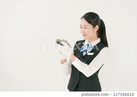A woman wearing gloves appraise treasures 127389818