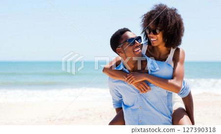 Couple Enjoys a Sunny Day at the Beach With Smiles and Laughter 127390318