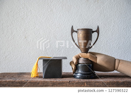 Graduating Student Achievement Trophy with Graduation Cap Display 127390322
