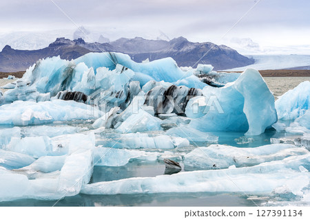 View of the melting glacier on Jokulsarlon Glacier Lagoon, Iceland 127391134