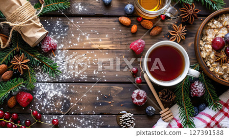 Flat lay of healthy breakfast with oatmeal, berries, honey, tea and fir twigs served on wooden table Flat lay of healthy breakfast with oatmeal, berries, honey, tea and fir twigs served on wooden table 127391588