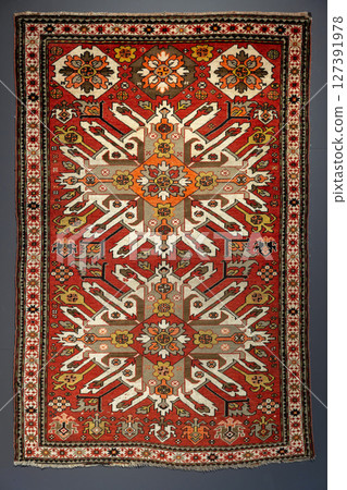 Colorful woolen carpet with traditional ethnic geometric ornament 127391978