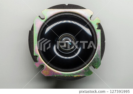Detailed view of a metal speaker component showing its circular design Detailed view of a metal speaker component showing its circular design 127391995
