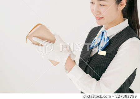 A woman wearing gloves assessing branded products A woman wearing gloves assessing branded products 127392789
