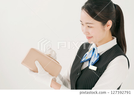 A woman wearing gloves assessing branded products A woman wearing gloves assessing branded products 127392791