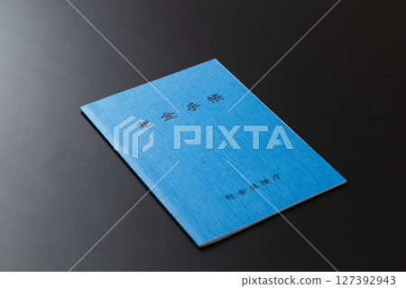 Pension book on a black background 127392943